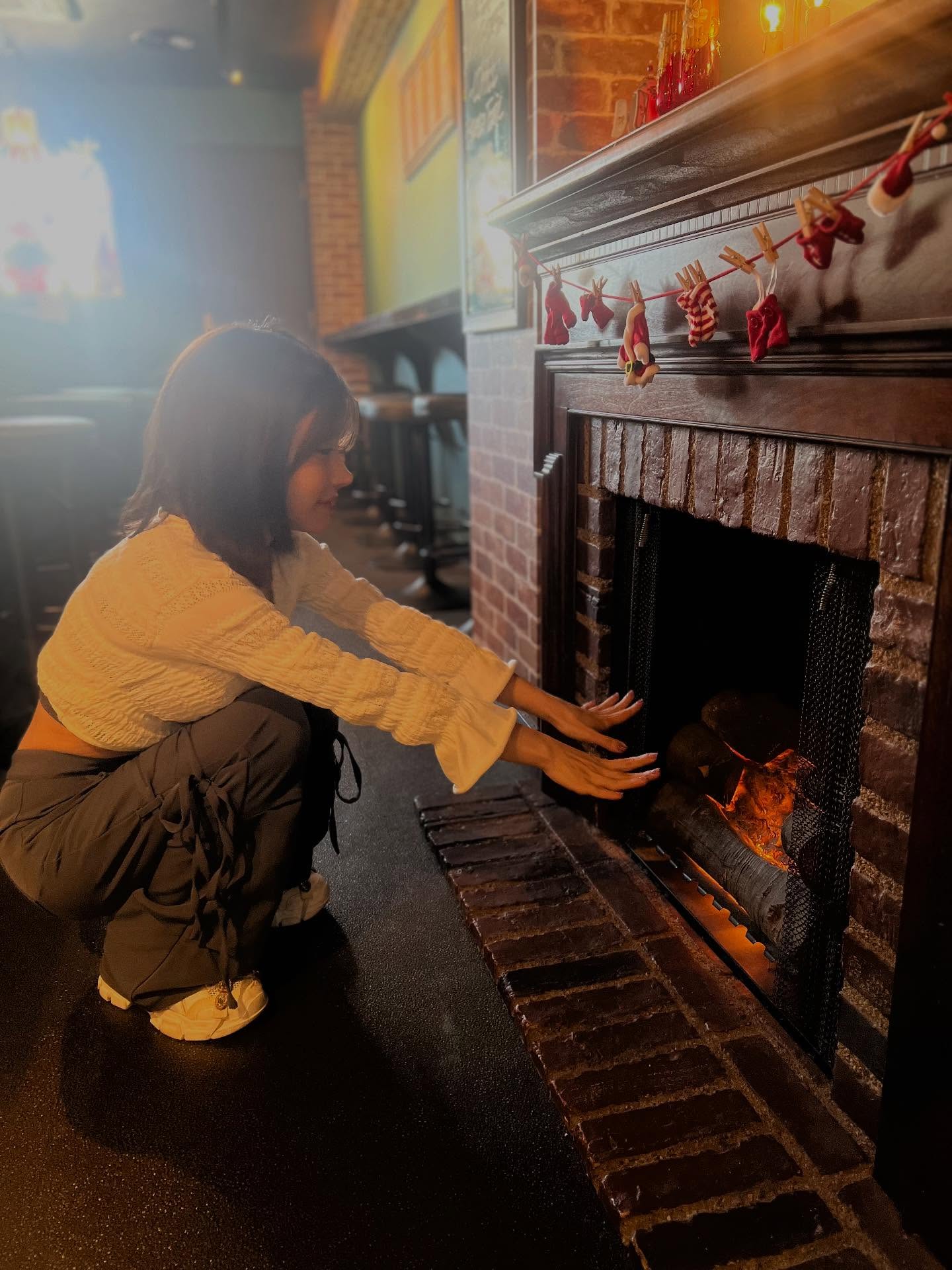 Candid portrait of Rena by a fireplace